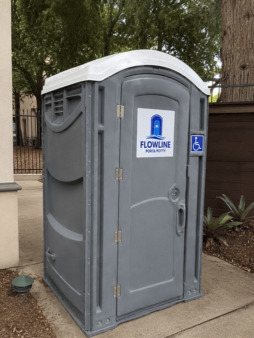 ADA accessible wheelchair friendly portable restroom on a paved walkway
