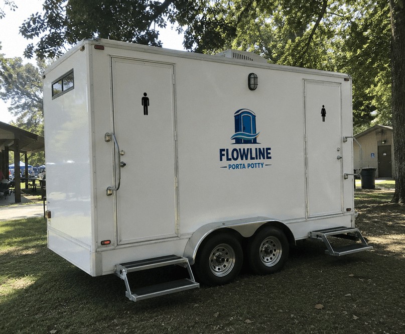 Luxury restroom trailer with fold-out steps set up at a park event